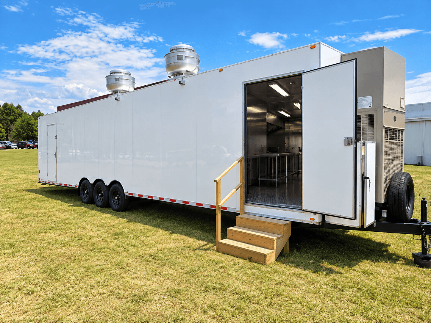 Mobile kitchen trailer with an open entrance, access stairs and rooftop ventilation