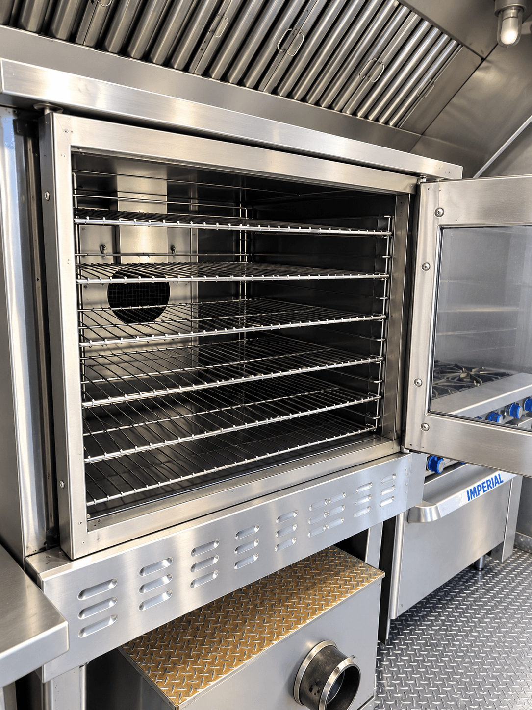 Commercial convection oven with racks inside a kitchen trailer