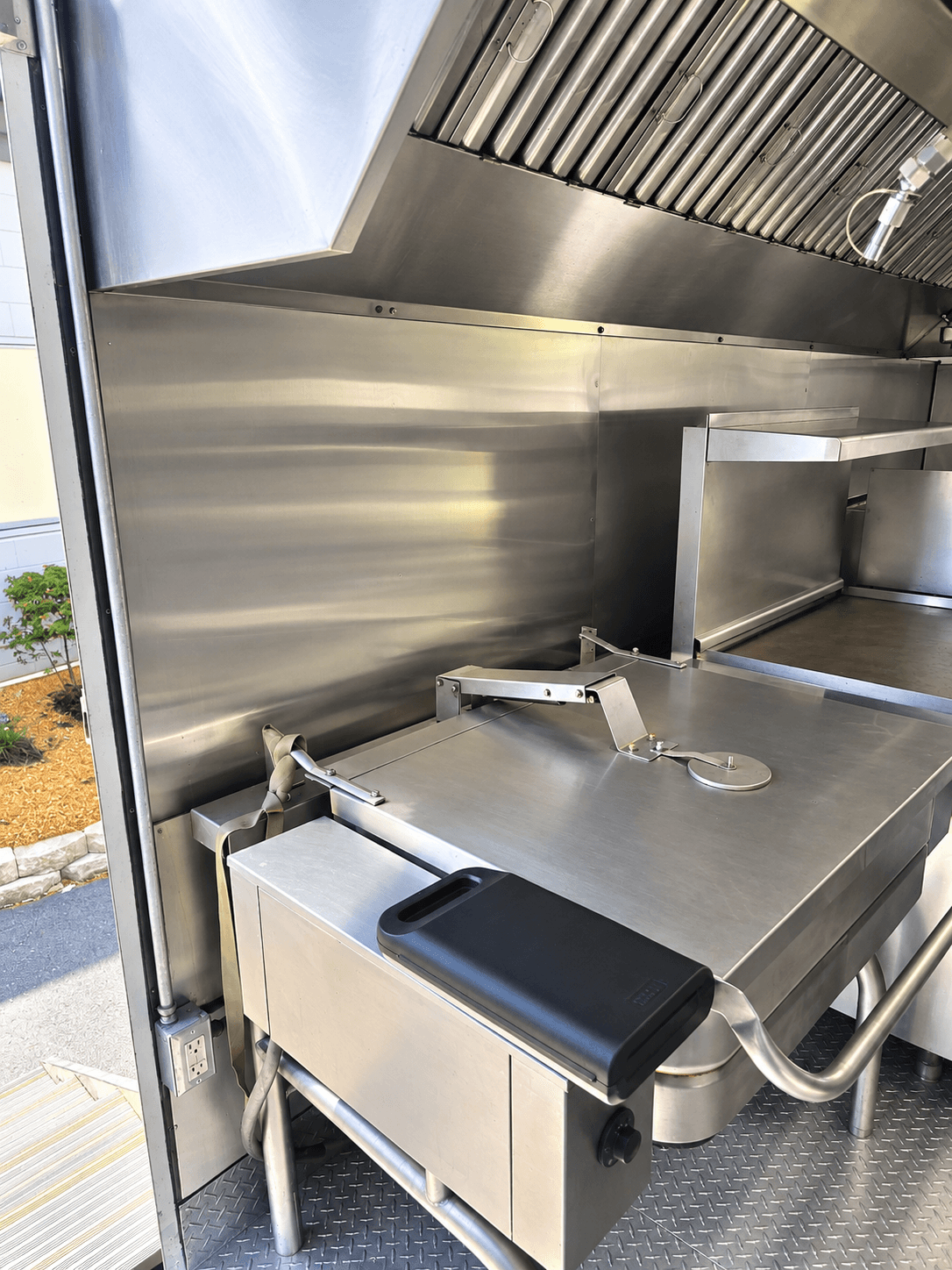 Commercial tilting skillet under a kitchen extraction hood